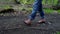 Man\'s feet walking on a path in a forest