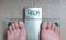 Man& x27;s feet on weight scale - Help