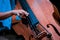 Man`s fingers play strings on his double bass during live jazz performance