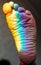 Man`s foot in the color of the rainbow