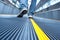 Man\'s foot walking in airport escalator