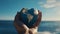 Man\\\'s gentle touch on heart-shaped globe symbolizes hope for sustainable future.