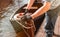 Man s hand with boat tiying rope. Sailor seaman gondolier Yachtsman moors his motor boat at jetty. Close up hands and bow of the b