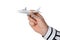 A man\'s hand in a classic shirt holds a model of a passenger airliner.