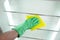 Man`s hand cleaning the kitchen fridge