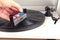 Man`s hand cleaning vinyl with special brush - turntable vinyl record player, vintage record player. Trends in music concept.