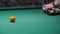 a man\\\'s hand collects colored balls after playing billiards and prepares a new game. spend free time