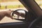 man\'s hand corrects the side mirror in the car, retro toning