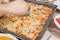 A man`s hand cuts a homemade pizza with a special round knife