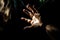 Man\\\'s hand on dark background with light beam. Close up Ai generative