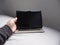 man\'s hand firmly grasps the sleek tablet, its modern design perfectly fitting within his grasp. With a determined look,