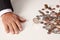 Man\'s hand flat after tossing coin that is spinning