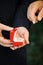 Man`s hand going to take wedding ring from red box