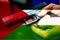 A man\'s hand with a gun against the background of the Palestinian flag.