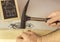 Man\'s hand hammering nail in wood