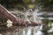 A man`s hand hitting the water.