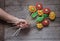 Man`s hand holding a bouquet of gingerbread flowers on rustic wo