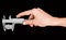 Man\'s hand holding a caliper during measuring