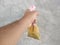 a man& x27;s hand is holding a drink in a plastic bag with a red pipette, the drink in Indonesian is called es cendol dawet