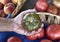 A man`s hand holding a green tomato at a farm stand in New Jersey.