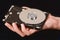 Man\'s hand holding a hard drive taken apart