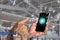 A man\\\'s hand holding a phone with the symbol for utilizing internet applications, booking lodging, booking flights,