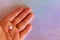 A man`s hand holding a pill on a festive litmus colored background. Drug for impotence. Medicines used for sex