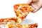 Man`s hand holding a slice of salami and sweetcorn pizza. White