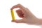 man\'s hand holding a yellow battery or battery on a white background isolated.