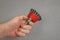 A man`s hand holds a bowl wire brush. A tool for woodworking as well as stripping surfaces of corrosion, scale, or rust. Side vie