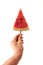 A man`s hand holds a juicy piece of watermelon lolly on a white background with space for text. The concept of fruit ice