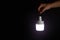A man\\\'s hand holds a portable rechargeable LED emergency light