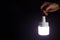 A man\\\'s hand holds a portable rechargeable LED emergency light