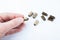 A man`s hand holds a rubber bullet on a white background