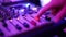 Man\'s hand increasing the volume on the mixing console.