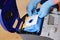 A man`s hand installing a clean empty dust bag in a vacuum cleaner