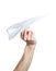 Man\'s hand launching white paper airplane