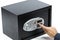 Man\'s hand opening electronic door of a safe deposit box