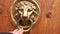 A man s hand opens the door, a close-up photo. The hand holds onto the antique metal handle. Old Door Knob