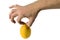 A man\'s hand pinching a lemon with two fingers