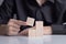 The man`s hand placed a wooden cube on table. Business strategy and plan. Copy space. Mockup for letters, symbol, picture text