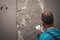 Man`s hand plastering a wall with trowel. Construction worker. Masonry tool. Construction industry. Selective focus