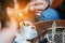 Man`s hand pours coffee into a cup