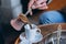 Man`s hand pours coffee into a cup