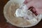 Man`s hand pours piece of raw fish in flour