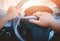 A man`s hand is pressed to the horn of a car to warn vehicles that are not complying with traffic laws, which could pose a danger