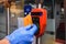 A man`s hand in a protective medical glove applies a card to an automatic toll terminal in a modern electric train, close-up