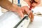 Man\'s hand screwing with a red screwdriver