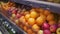 Man`s hand selecting fresh fruits in grocery store produce department from shelf. Young guy is choosing oranges in