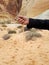 Man`s hand sifting sand in Valley of Fire State Park, Las Vegas, Nevada